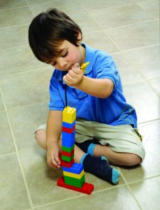photo of young child playing with legos