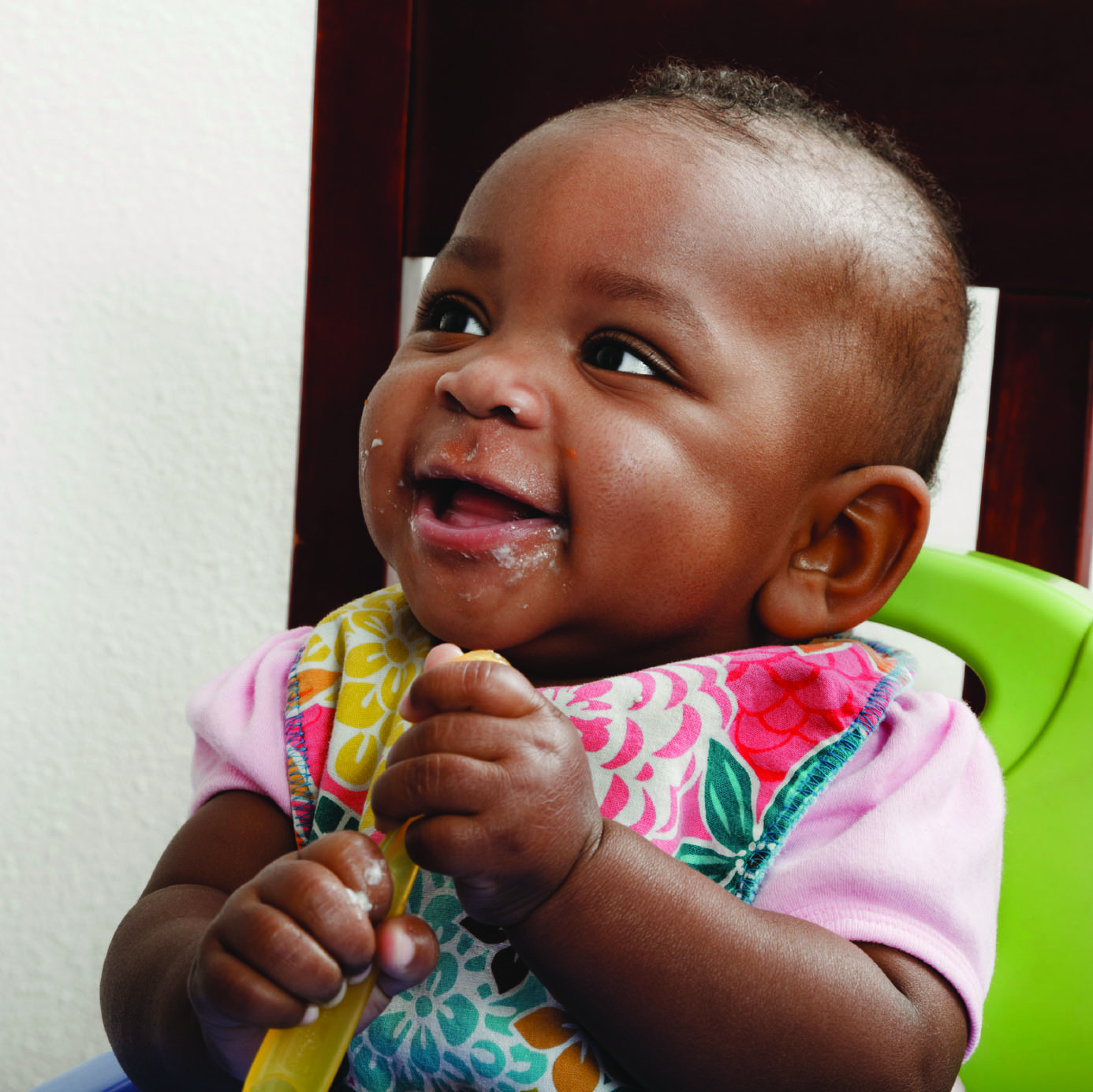 smiling baby with spoon